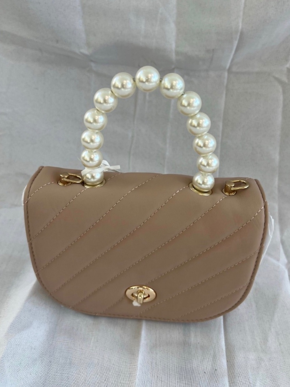 Small Tan purse with a crossbody and pearl handle
